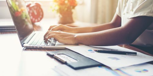 A young business woman typing on her laptop.