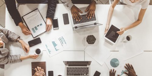 A group of industry professionals gathered together for a discussion at a table.